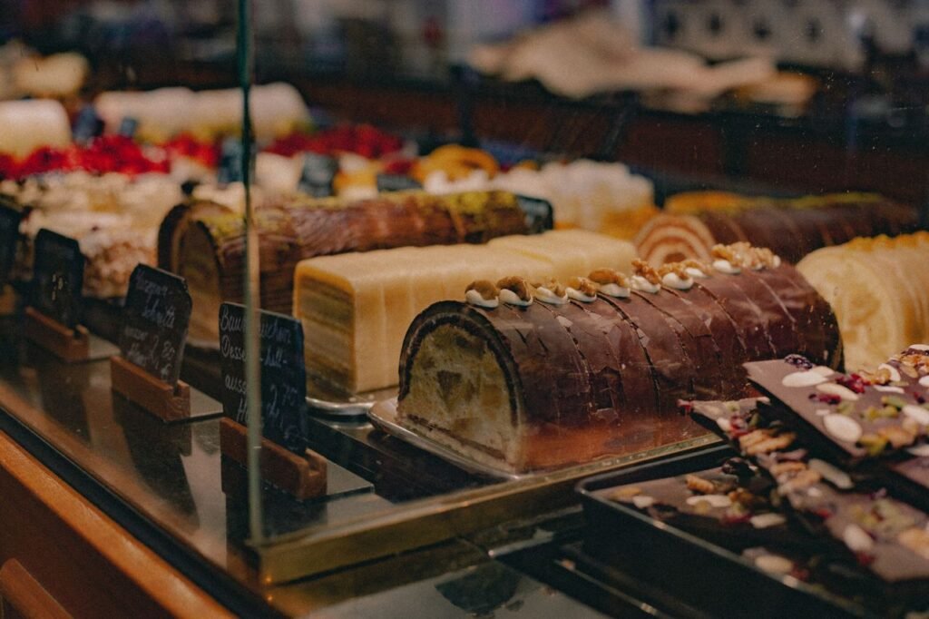 Menu A tempting assortment of pastries and cakes displayed in a bakery shop window.