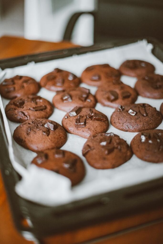 Menu Close-up of homemade chocolate cookies on a baking sheet, perfect for dessert lovers.
